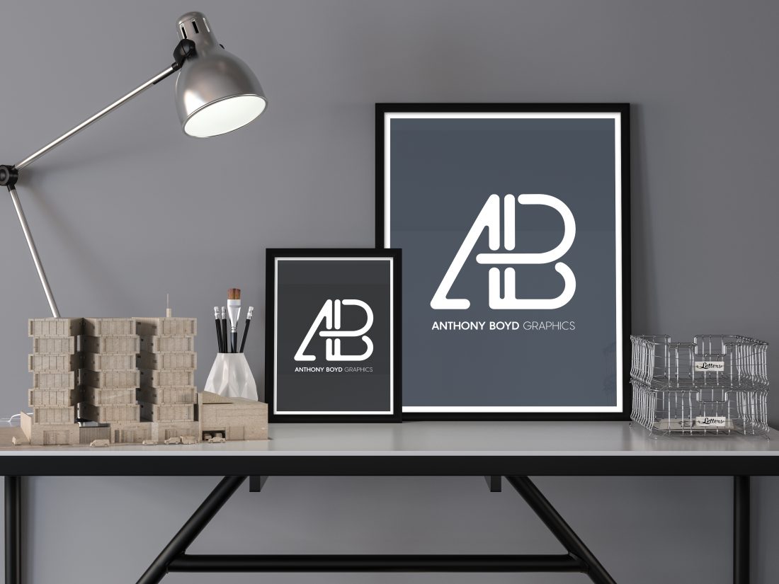 Image of 2 framed photos on a desk with lamp